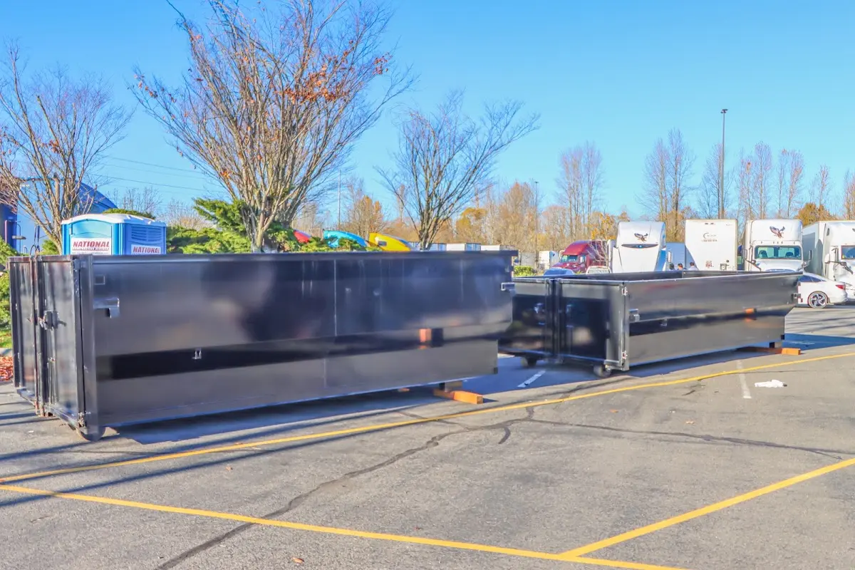 Professional dumpster rental service with roll-off container on residential driveway in Chenango